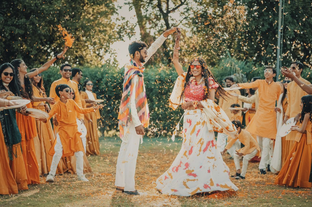 Traditional cultural performers entertaining guests at a multicultural wedding celebration with music and dancing.