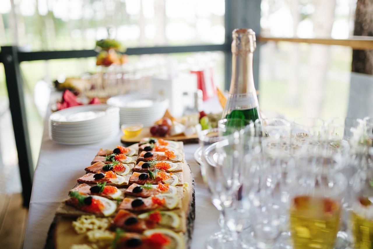 Sunset coastal wedding reception with seafood stations and champagne tower showcasing luxury food experiences