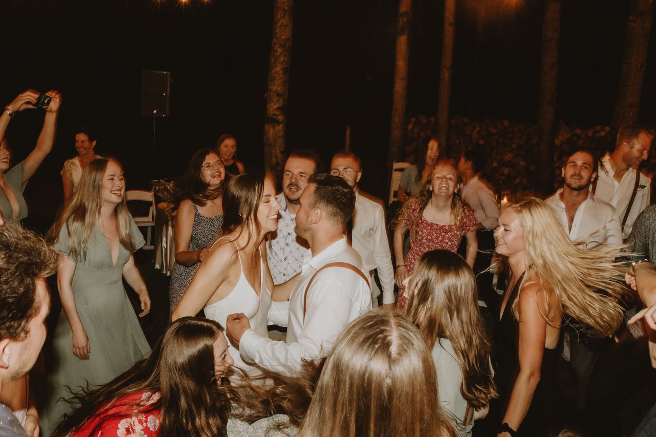 Packed Melbourne wedding dance floor with bride, groom, and guests enjoying a live band performance during an unforgettable reception celebration.