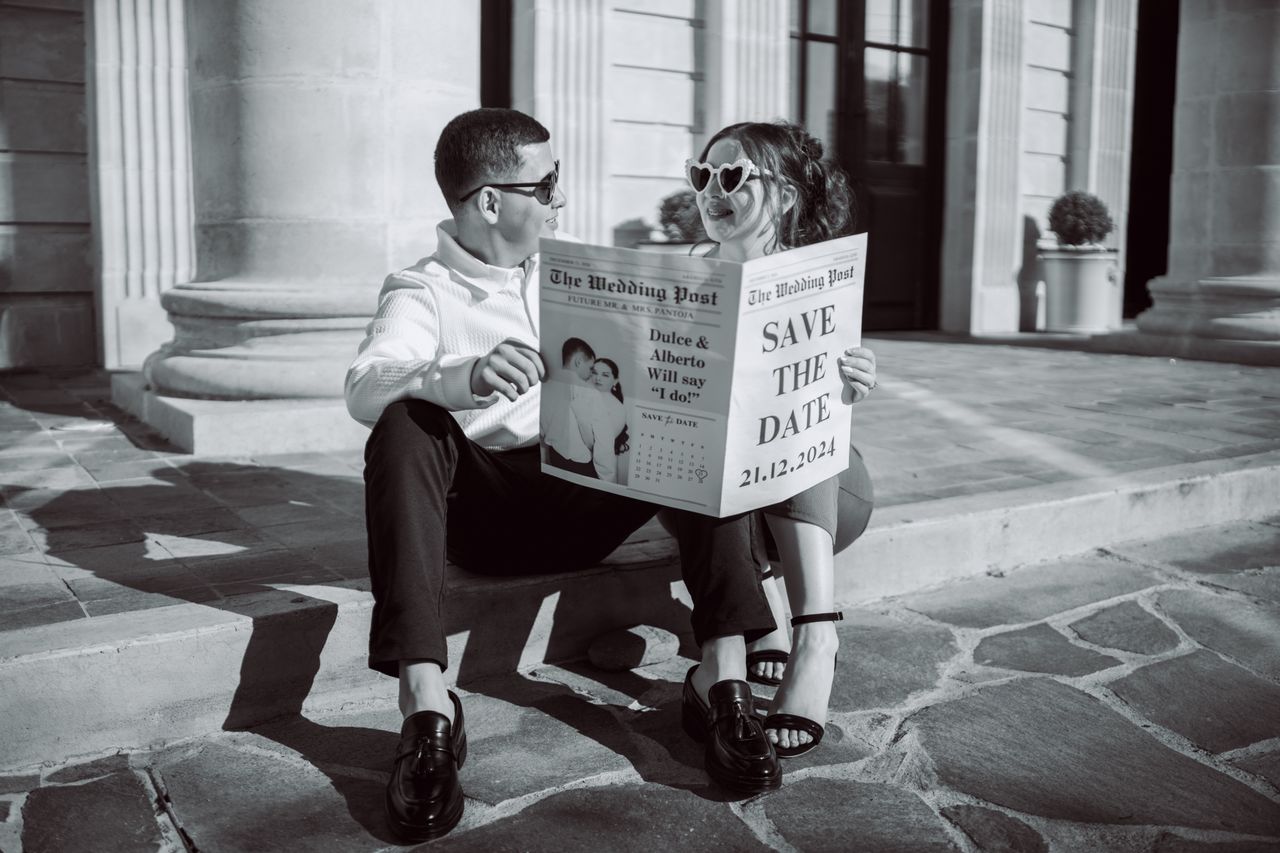 Engaged couple choosing between peak and off-peak Melbourne wedding dates outside an elegant venue.