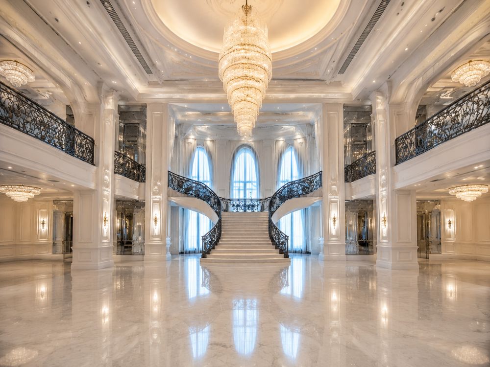 Grand Melbourne wedding venue interior showcasing architectural features, chandeliers, balconies, and Neo Deco luxury atmosphere.