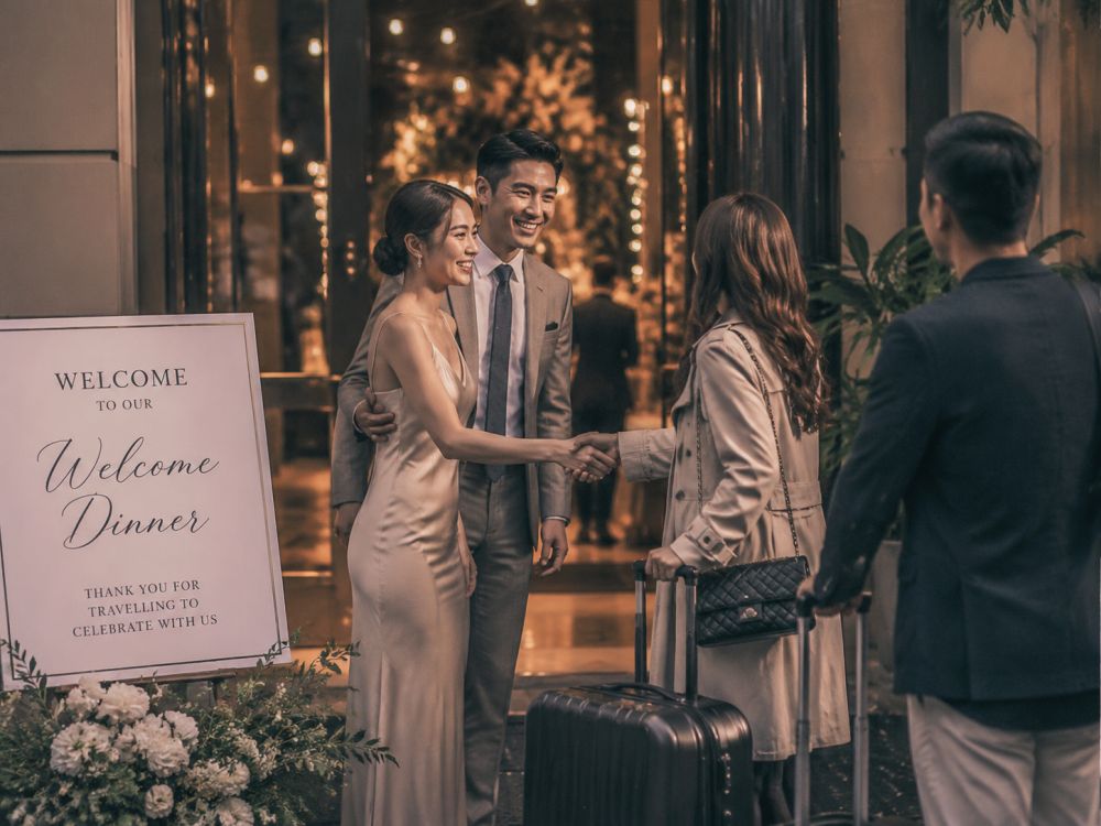 Couple welcoming travelling guests at a Melbourne wedding welcome dinner venue before the wedding celebration begins