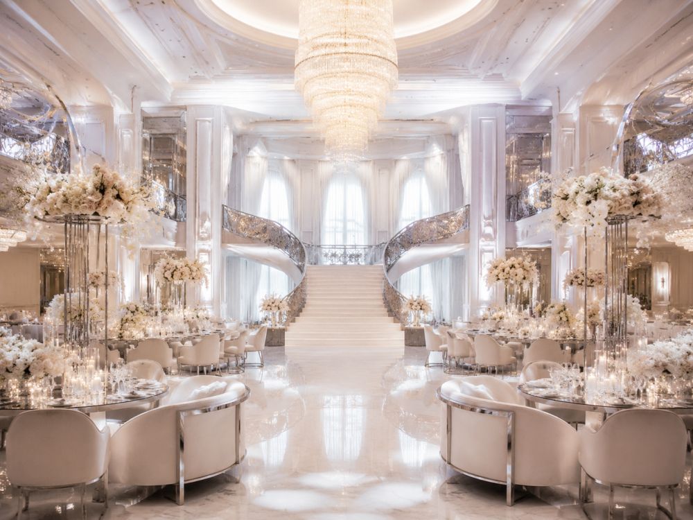 Luxurious Neo Deco wedding reception ballroom in Melbourne featuring grand architecture, sculptural florals, chrome accents, and modern Art Deco styling.