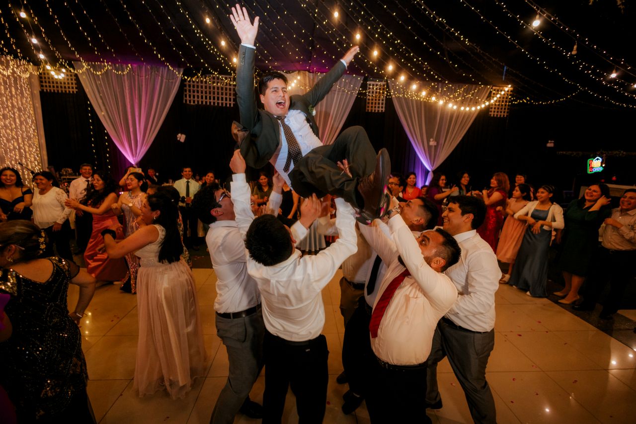 Guests celebrating on a full wedding dance floor after well-timed reception formalities