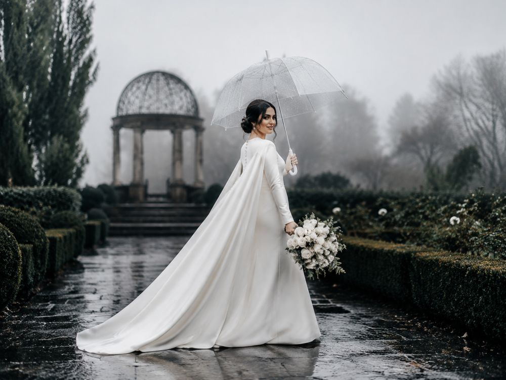 Bride wearing a winter wedding gown walking through a misty Melbourne garden after rain.