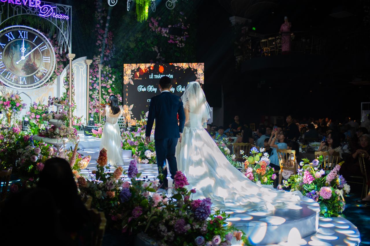 Bride and groom entering a warm candlelit Melbourne winter wedding reception during rainy weather.