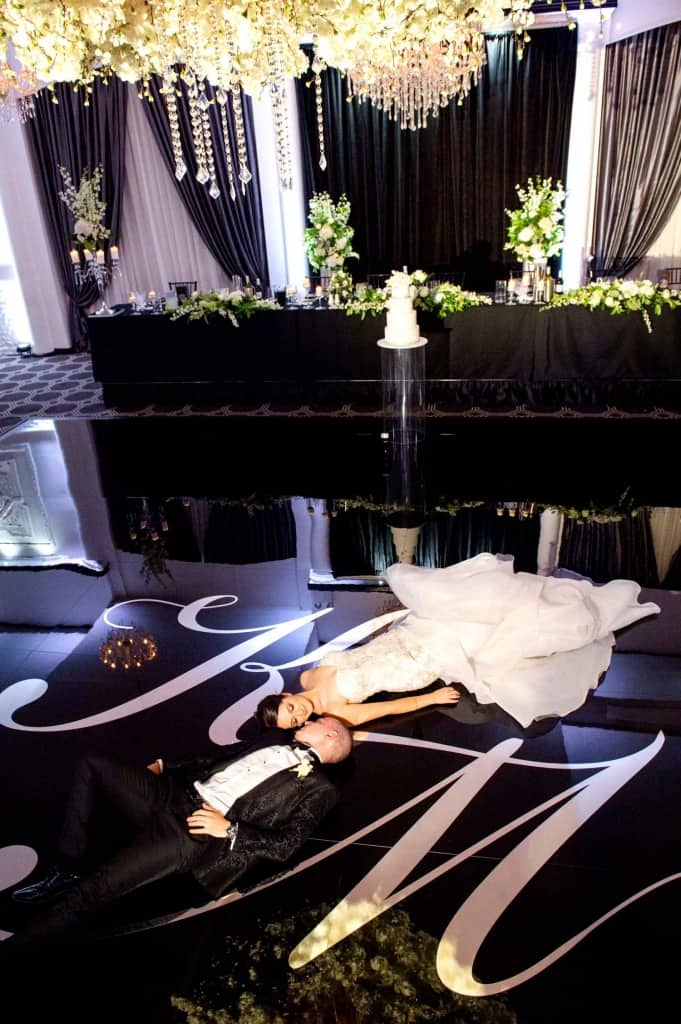 bride and groom on black floor at vogue ballroom