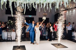 bride and groom walk out onto dancefloor